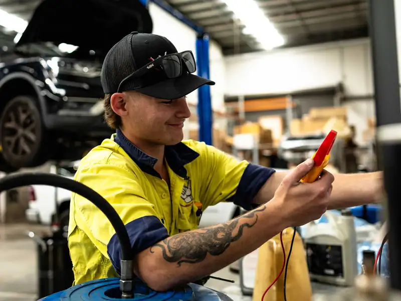 Electrician testing equipment in the Clontarf workshop
